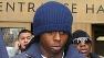 Rapper Lil Wayne, right, exits Manhattan criminal court.