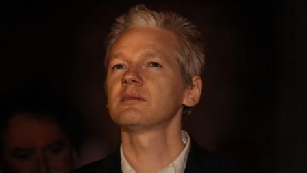WikiLeaks founder Julian Assange waves legal papers as he leaves Britains High Court Thursday Dec. 16, 2010 in London, England.