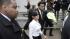 British singer Amy Winehouse, center, escorted...