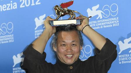Director KIM ki-duk shows the Golden Lion he won for his movie Pieta at the awards photo call during the 69th edition of the Venice Film Festival in Venice, Italy, Saturday, Sept. 8, 2012. (AP Photo/Joel Ryan)