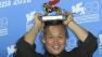 Director KIM ki-duk shows the Golden Lion he won for his movie Pieta at the awards photo call during the 69th edition of the Venice Film Festival in Venice, Italy, Saturday, Sept. 8, 2012. (AP Photo/Joel Ryan)