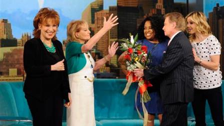 Barbara Walters, second left, receiving flowers from Regis Philbin, second right, on her first day back to The View, in New York on Monday, March 4, 2013, after being sidelined for six weeks by chickenpox and a concussion.