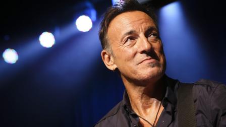 Musician Bruce Springsteen stands on stage at the Stand Up for Heroes event at Madison Square Garden, Thursday, Nov. 7, 2013, in New York. (John Minchillo/Invision/AP)