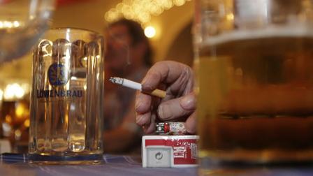 A participant of a smoker demonstration holds a cigarette during an event against a scheduled anti smoker law in Munich, southern Germany, on Monday, Dec. 10, 2007. (AP Photo/Christof Stache)