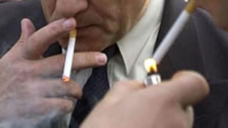 A group of men smoking cigarettes.