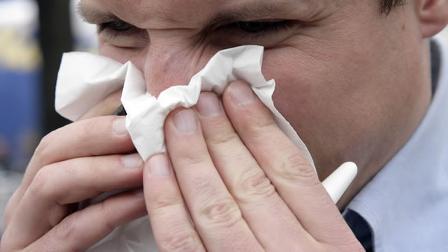 Allergic Lorenz Roatzsch blows his nose in Hanover, northern Germany, Wednesday, April 11, 2007.