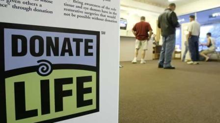 A donate life sign containing information about organ transplants and donation sits near the entrance of the Delaware, Ohio Bureau of Motor Vehicles Friday July 11, 2003.