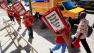 Nurses from Kaiser Oakland Hospital including, Kathy Donohue, at right, and Katy Roemer, center, carry picket signs to be loaded onto trucks at the California Nurses Association headquarters , Wednesday, Sept. 21, 2011 in Oakland, Calif.