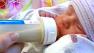 Baby feeding on bottle