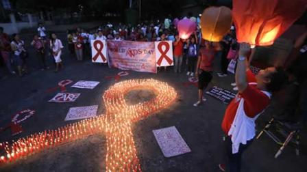 Filipinos release into the air paper lanterns to mark World AIDS Day