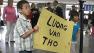 Colin McFadden with a sign waiting for the 27-year-old brother that can save his life