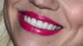 A smiling woman wearing lipstick