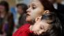 Adria Roman, 18, of Boston, and her son, Diano Perez, 3, both part of the Just A Start House program, attend a rally at the Statehouse in Boston