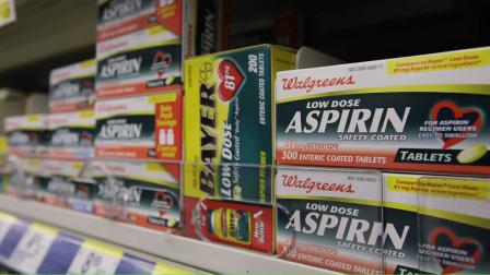 Packages of aspirin fill the shelves of a drugstore, Tuesday, Aug. 11, 2009 in Chicago. A study suggests colon cancer patients who took aspirin reduced their risk of death from the disease by nearly 30 percent.