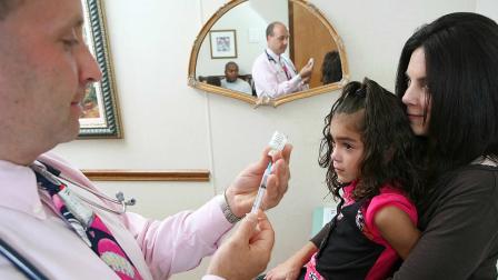 In support of the American Lung Associations Faces of Influenza initiative, local face of influenza and mother of two young children, Tara Watson, holds her daughter Hannah as she prepares to receive her seasonal flu shot.