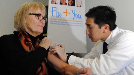 Pharmacist Jason To gives a flu shot to Diane Marie Dash during the Flu + You event at Montclair Recreation Center, sponsored by the National Council on Aging and Sanofi Pasteur on Tuesday, Oct. 22, 2013, in Denver. (Jack Dempsey / AP Images for National Council on Aging and Sanofi Pasteur)