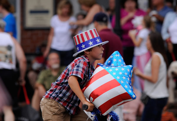 A youth on a bicycle joins the Water Street...