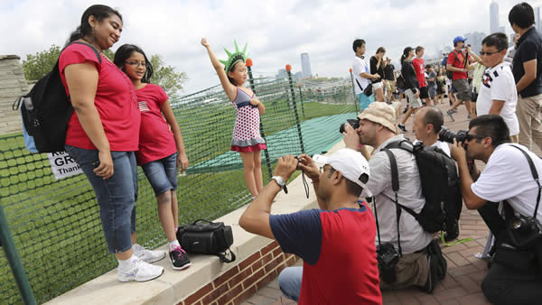 Photographers take photos of people posing for...