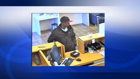 Supected bank robber robbing teller at a Bank of the West branch in San Jose