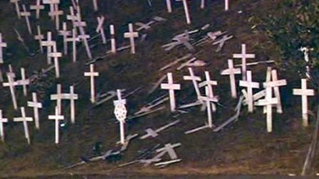 Someone knocked over as many as 20 crosses at a controversial memorial in Lafayette that honors fallen soldiers.