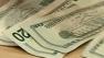 Twenty dollar bills laid out on table