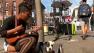 Musician plays her guitar on Berkeleys Telegraph Avenue