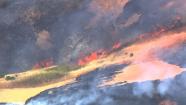 Firefighters have contained a four-alarm vegetation fire in Orinda  Monday afternoon.