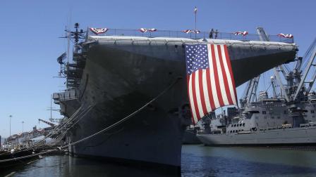 A large American flag hangs from the flight deck of the USS Hornet during Fourth of July festivities in Alameda, Calif., Monday, July 4, 2011.