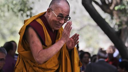 Tibetan spiritual leader the Dalai Lama greets devotees as he arrives for the Kalachakra initiation session, in Bodh Gaya, Bihar, India, Monday, Jan. 9, 2012