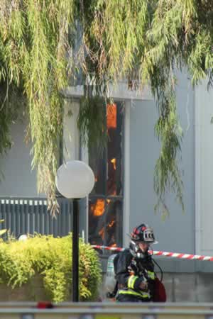 Firefighters work to extinguish a two-alarm...