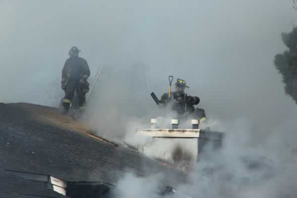 Firefighters work to extinguish a two-alarm...