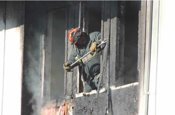 Firefighters work to extinguish a two-alarm...