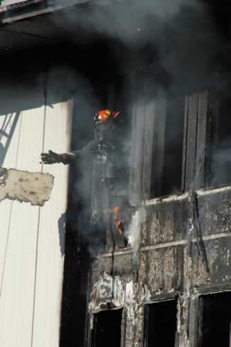 Firefighters work to extinguish a two-alarm...