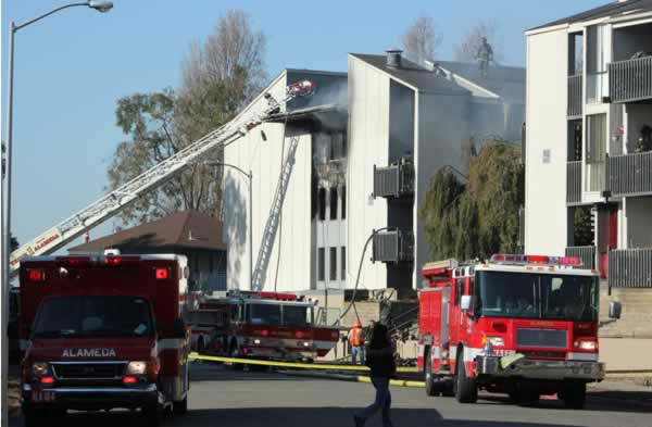 Firefighters work to extinguish a two-alarm...