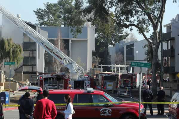 Firefighters work to extinguish a two-alarm...