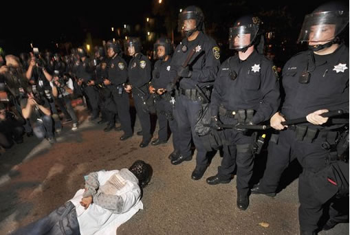 A demonstrator lies on the ground during a...
