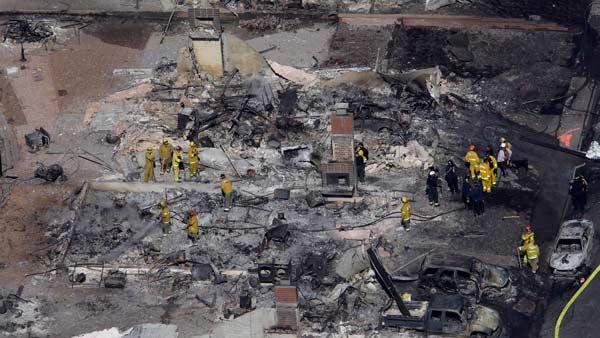 Firemen work on the remains of a home damaged by a massive fire in a mostly residential neighborhood in San Bruno, Calif., Friday, Sept. 10, 2010.