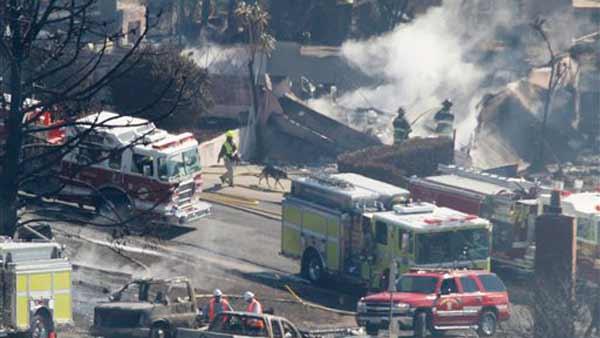 Firefighters work in a neighborhood following a massive gas line explosion in San Bruno, Calif., Friday, Sept. 10, 2010.