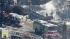 Firefighters work in a neighborhood following a...