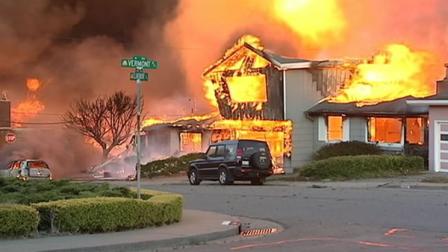 A home on fire after a PG&E gas pipeline exploded in a San Bruno neighborhood in September 2009.