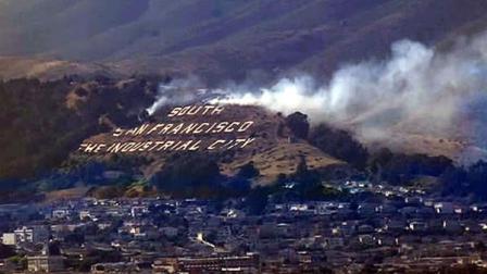 A grass fire burned dangerously close to the famous South San Francisco: The Industrial City sign Friday afternoon.