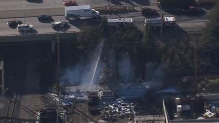 A grass fire near a Redwood City hardware store charred some trees, knocked out power and slowed Caltrain service Wednesday afternoon.