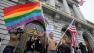 Billy Bradford of Castro Valley, Calif., waves a pair of flags outside City Hall while same-sex couple line up to see if they can be married in San Francisco, Thursday, August 12, 2010.