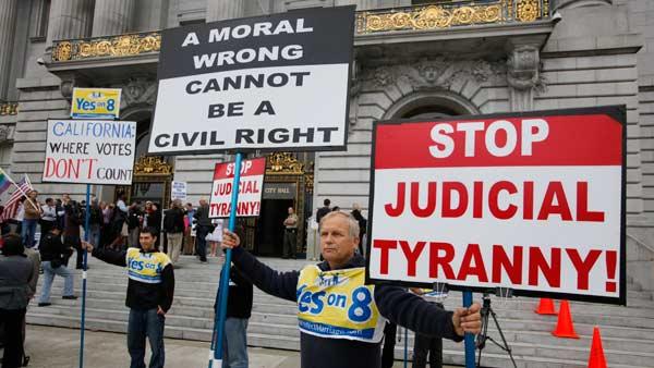 Victor Choban, left, of Sacramento, Calif., and Richard Otterstad, right, of Oakland, Calif., hold up signs outside City Hall as a few same-sex couples begin lining up to be married in San Francisco, Thursday, August 12, 2010.
