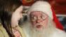 John Toomey, the naughty Santa Claus who was fired from Macys, visits with nine-year-old Retta Campbell of Sebastopol, Calif.