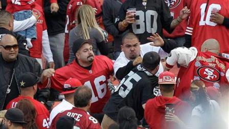 In this photo made Saturday, Aug. 20, 2011, football fans fight in the stands during a preseason NFL football game between the San Francisco 49ers and the Oakland Raiders in San Francisco.