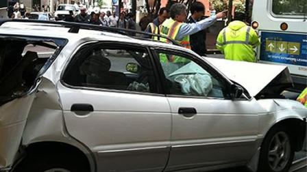 Accident on Market Street. Car wedged in between Muni bus and Muni streetcar.