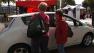 People looking at an electric vehicle in San Francisco