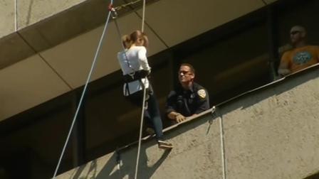 woman rapelling down building