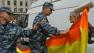 Russian soldiers confront a gay rights supporter.